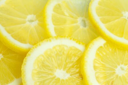 Background from bright juicy sliced lemon slices.の写真素材