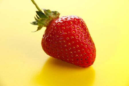 strawberries on a yellow backgroundの写真素材