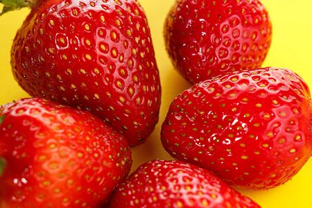 strawberries on a yellow backgroundの写真素材