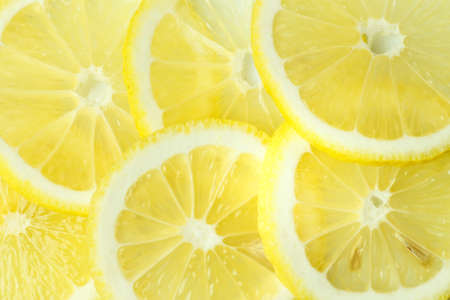 Background from bright juicy sliced lemon slices.の写真素材
