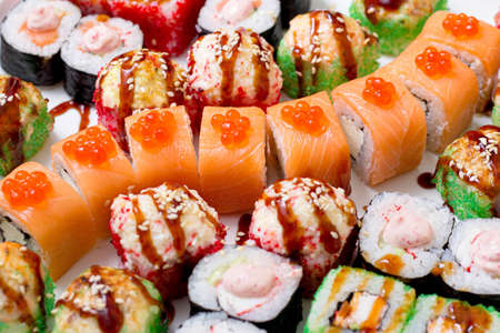set of different types of sushi on a white plateの写真素材