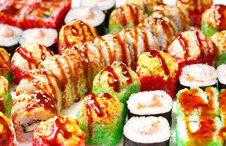 set of different types of sushi on a white plateの写真素材
