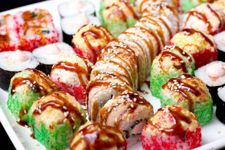 set of different types of sushi on a white plateの写真素材