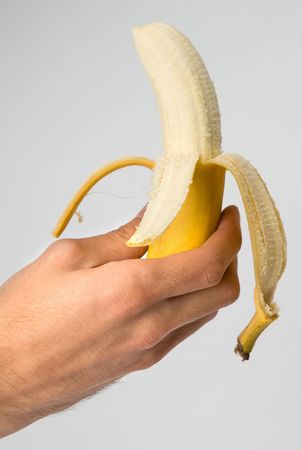 Hand holding a bananaの写真素材