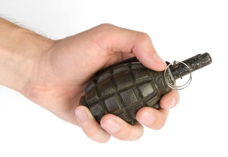old hand grenade in a man's handの写真素材