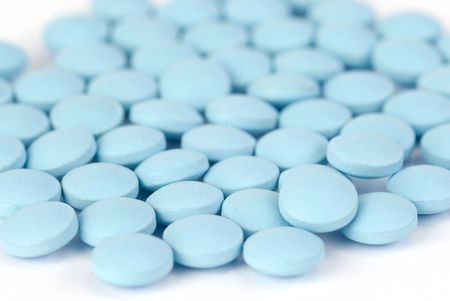  Blue pills on white with a shallow depth of fieldの写真素材