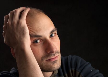 Portrait of young pensive guyの写真素材