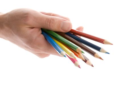 human hand holding color pencils over whiteの写真素材