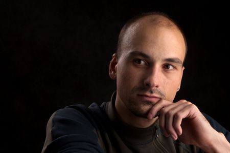 Low-key portrait of pensive young manの写真素材