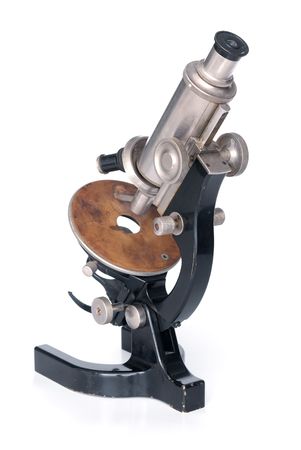 An old-fashioned microscope isolated over whiteの写真素材