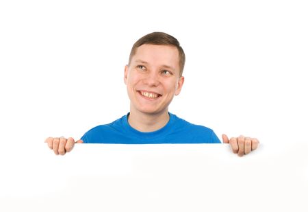 Portrait of a handsome young man looking over a blank boardの写真素材