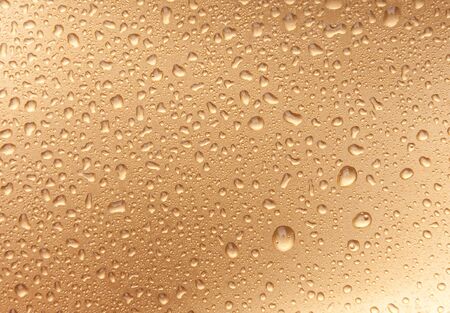 golden waterdrops from aboveの写真素材