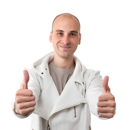young man showing thumb up and smiling isolated on white backgroundの写真素材