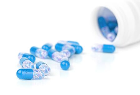 closeup blue pills isolated on a white backgroundの写真素材
