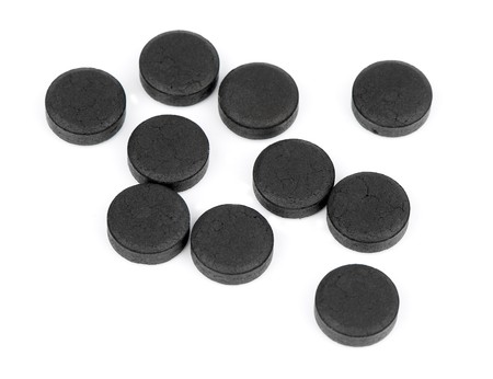 Medical Tablet activated coal isolated on a whiteの写真素材