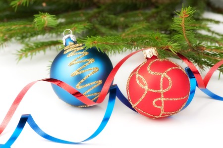 Christmas baubles with curly ribbon and christmas tree on a white backgroundの写真素材