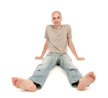 relaxed man sitting on the floor over whiteの写真素材