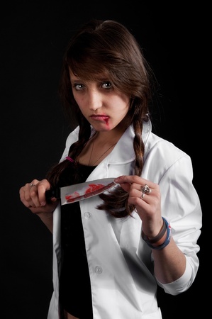 crazy nurse holds a bloody knifeの写真素材