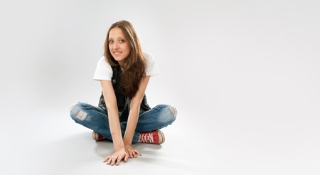 Young girl wearing red sneakers and jeansの写真素材