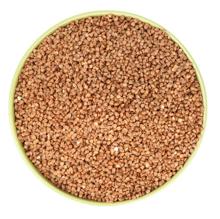 raw buckwheat in bowl isolatedの写真素材