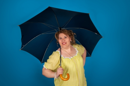 Cute fat woman holding umbrellaの写真素材