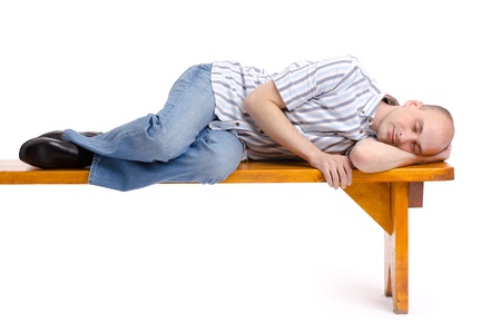 man sleeping on a bench isolated on whiteの写真素材