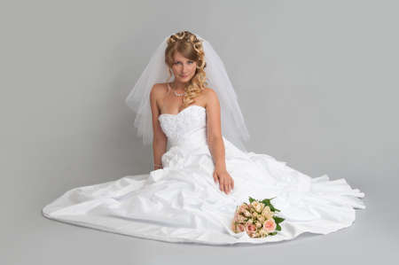 beautiful bride in a wedding dress sittingの写真素材