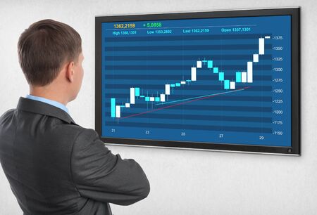 Businessman checking stock market on monitor