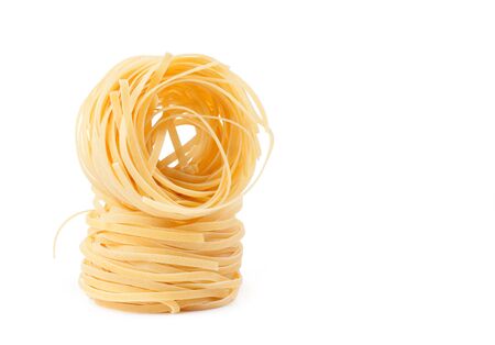 Italian pasta fettuccine nest isolated on white backgroundの写真素材