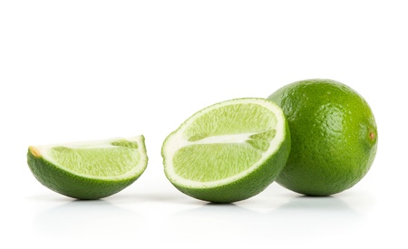 Fresh limes isolated on whiteの写真素材