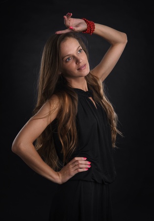 Beautiful young woman. Dark backgroundの写真素材