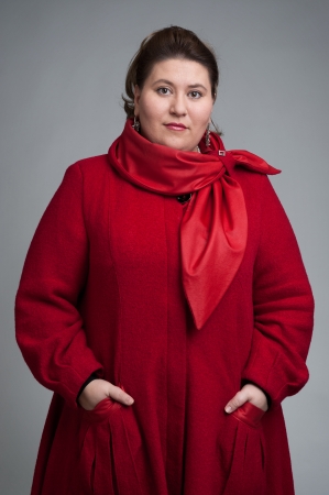 fat woman in red coatの写真素材