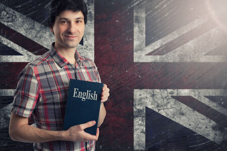 Man with a book over Grungy UK Flag の写真素材