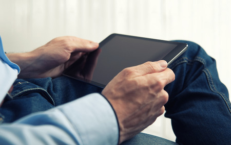 Man reading something on Tablet PCの写真素材