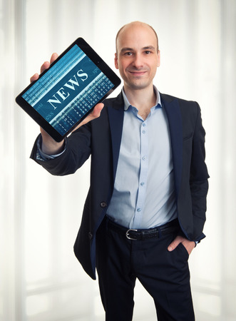 Global online news on a tablet screenの写真素材