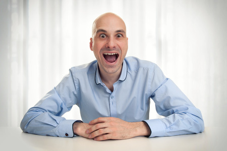 Funny man with crazy surprised lookの写真素材