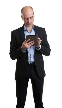 Businessman using his tablet computer. Isolated on white の写真素材