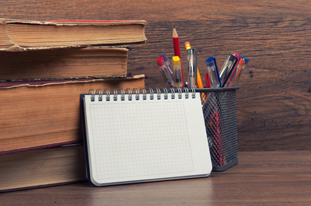school supplies on a desk and notebook with copy space