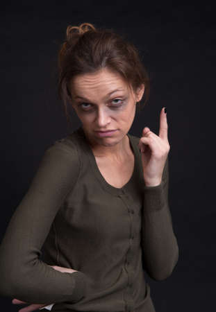 portrait of drunk young woman over black backgroundの写真素材