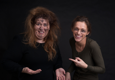 portrait of drunk two women over black backgroundの写真素材