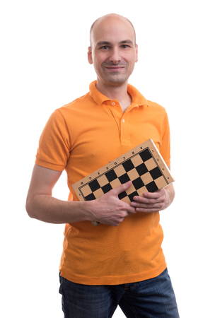 bald man holding a chessboard isolated on white backgroundの写真素材
