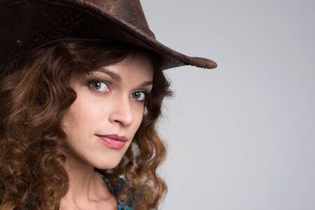 Young lady in a cowboy hat. Studio portraitの写真素材