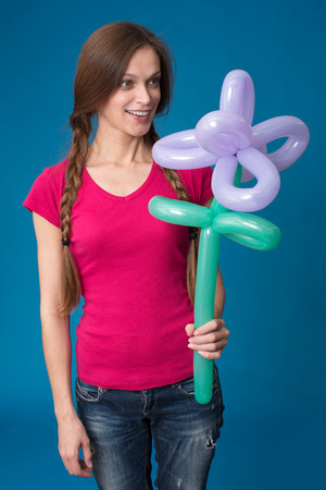 Portrait of beautiful girl with balloon flowerの写真素材
