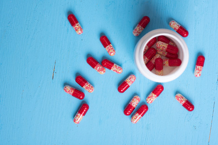 close up of red pill capsules. healthcare and medicine