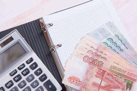 money, calculator and blank notebook with copy spaceの写真素材