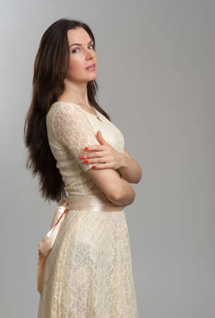 Fashion model wearing dress over grey backgroundの写真素材