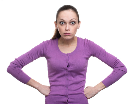Portrait of an angry woman looking at camera isolated on a white backgroundの写真素材
