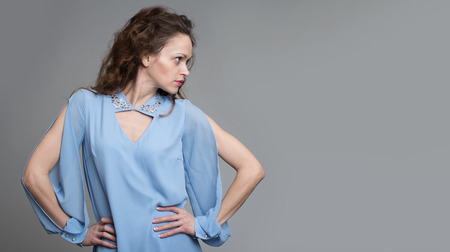 profile portrait of a beautiful woman with long curly hairの写真素材