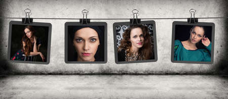 woman portraits hanging on the rope over gray concrete wall and floorの写真素材