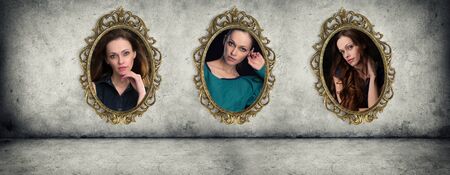 Retro ornate golden frames with portraits hanging on the concrete wallの写真素材